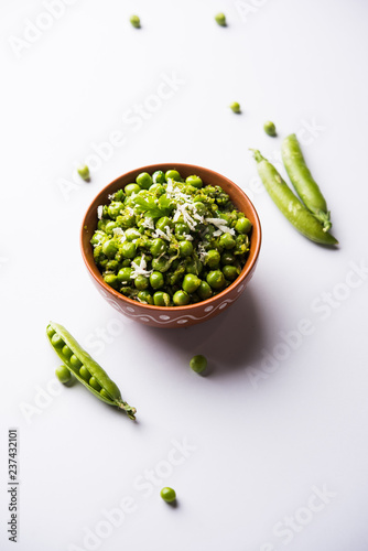 Green peas dry recipe or matar ki sookhi sabji, served in a serving pan or terracotta bowl. Selective focus photo