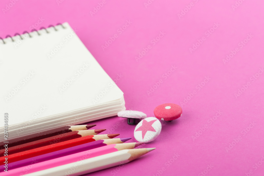 Pink working desk with empty notebook Pink working desk with empty notebook