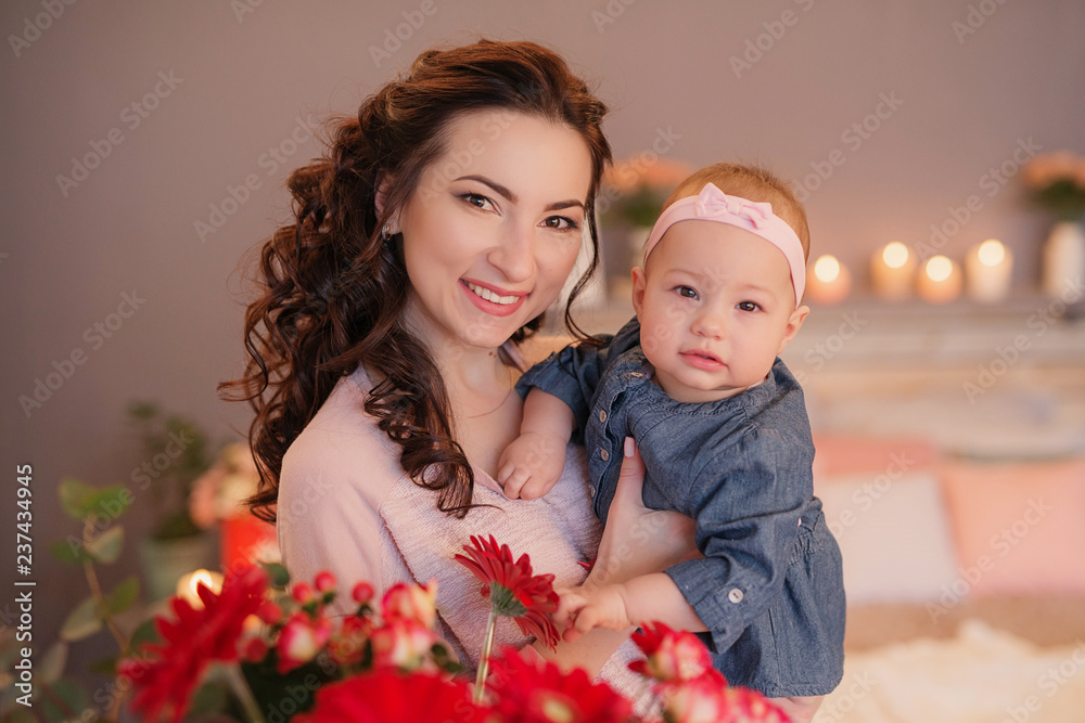 family photo session of mom and daughter on the bed with candles and flowers