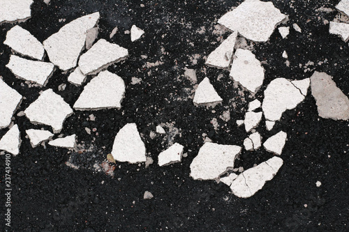 Asphalt background texture with pieces of painted concrete
