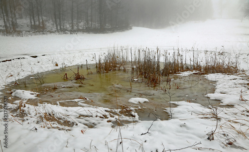 frozen pond in winter with white snow