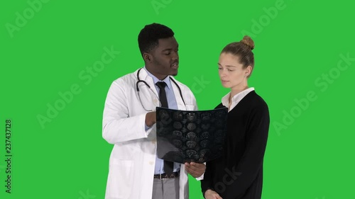 Young woman visiting radiologist for x-ray exam of her brain on a Green Screen, Chroma Key.