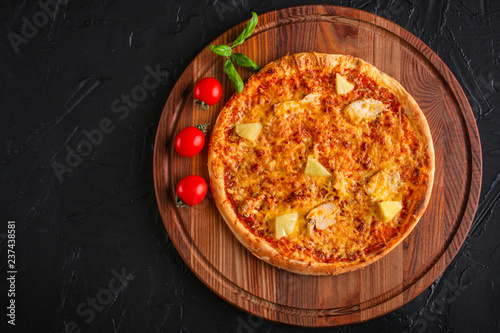 pizza, pineapple, chicken, tomato sauce, cheese, basil (pizza ingredients). Hawaiian pizza. Top view. copy space