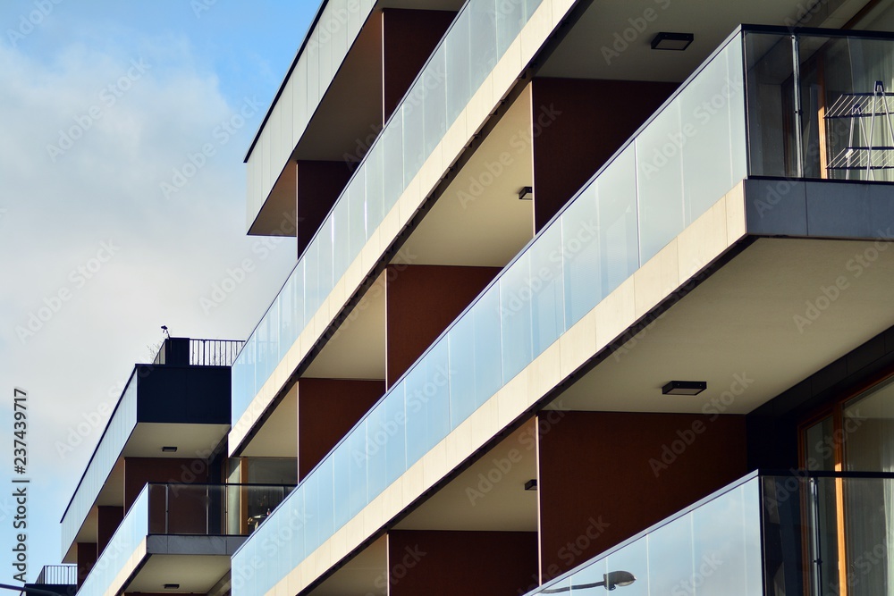 Modern apartment buildings on a sunny day with a blue sky. Facade of a modern apartment building Modern apartment buildings on a sunny day with a blue sky. Facade of a modern apartment building