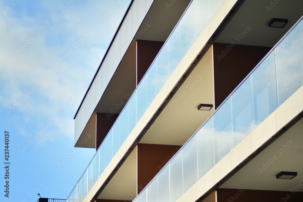 Fototapeta premium Modern apartment buildings on a sunny day with a blue sky. Facade of a modern apartment building