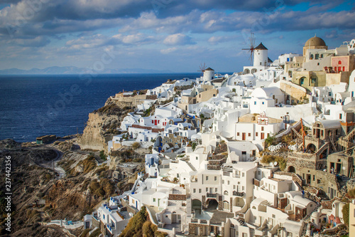 A panoramic view of the white city with blue roofs against the background of the Aegean Sea - the most romantic island in the world