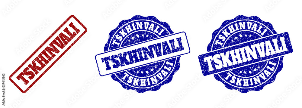 TSKHINVALI scratched stamp seals in red and blue colors. Vector TSKHINVALI labels with grainy effect. Graphic elements are rounded rectangles, rosettes, circles and text labels.