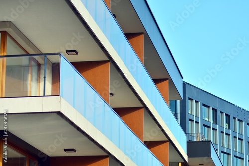 Modern apartment buildings on a sunny day with a blue sky. Facade of a modern apartment building © Grand Warszawski