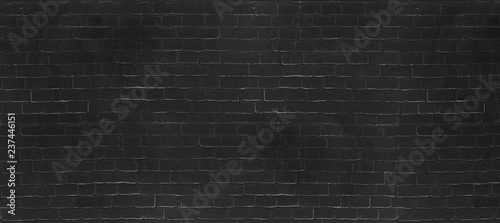 Vintage Black wash brick wall texture for design. Panoramic background for your text or image.