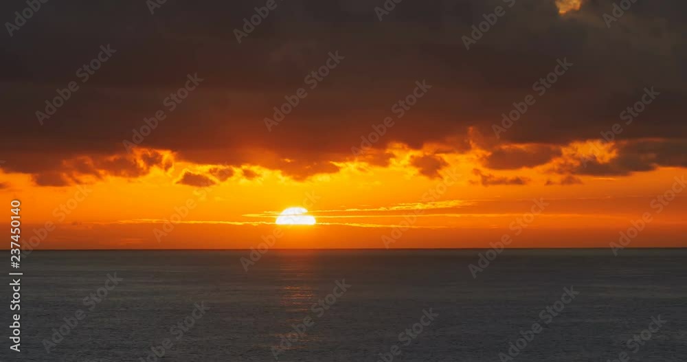 Red sunrise dawn over sea water surface and clouds time lapse Red sunrise dawn over sea water surface and clouds time lapse