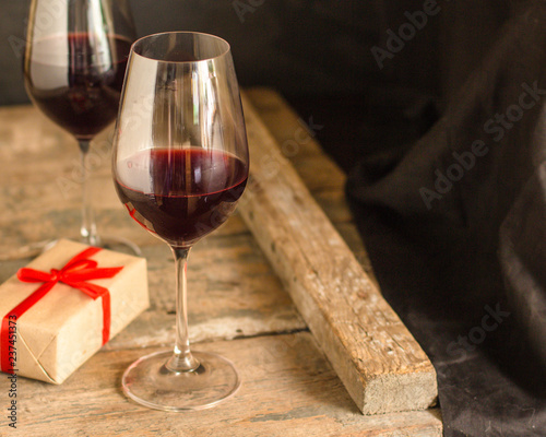 wine, red wine, transparent glass on a wooden table, a gift. Top view. copy space