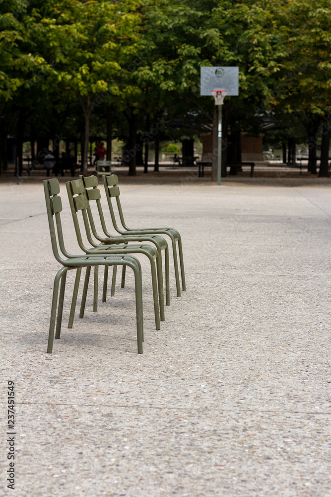 Line of chairs in front of basketball goal