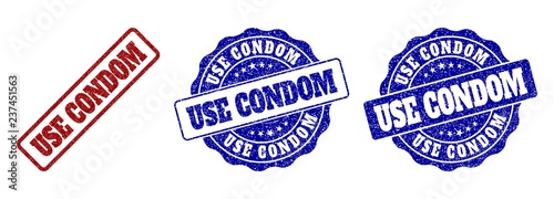 USE CONDOM grunge stamp seals in red and blue colors. Vector USE CONDOM marks with grunge effect. Graphic elements are rounded rectangles, rosettes, circles and text labels.