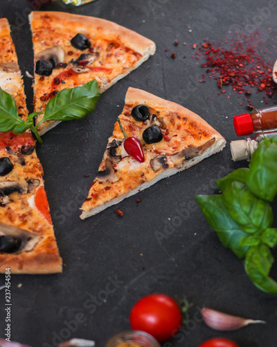 pizza, mushrooms, olives, chicken, tomato sauce, cheese, (pizza ingredients). hot pizza. Top view. copy space