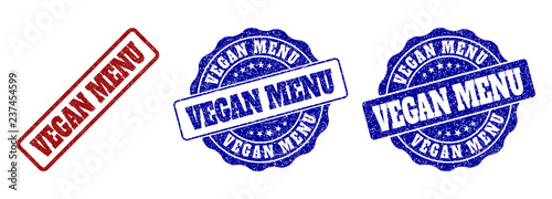 VEGAN MENU grunge stamp seals in red and blue colors. Vector VEGAN MENU signs with grunge surface. Graphic elements are rounded rectangles, rosettes, circles and text titles.