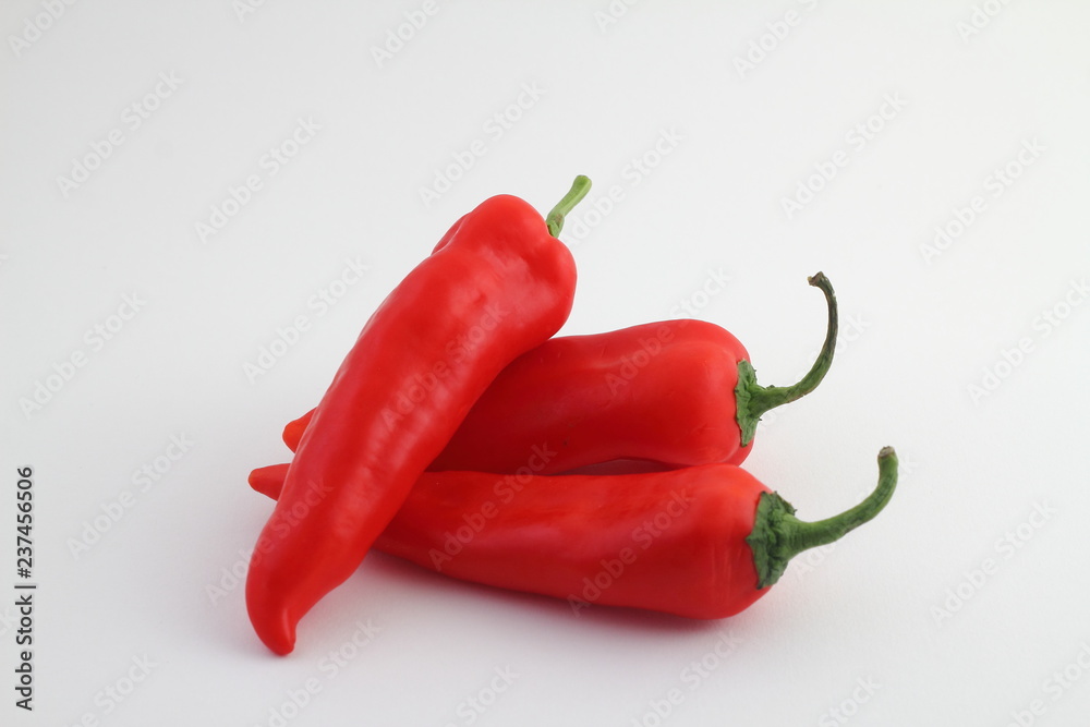 Red bell pepper closeup photo on white background. Fresh vegetable isolated. Fresh ripe bell pepper. Whole pepper closeup. Natural diet food. Salad or soup cooking ingredient. Autumn harvest vegetable
