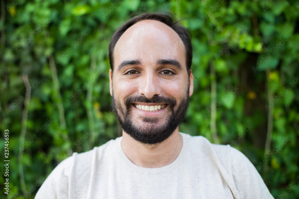 Close-up a man with a beard smiling Close-up a man with a beard smiling