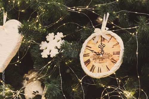 Christmas tree with decoration with filter. Toy clock and snowflake with festive lights on Christmas tree. Merry Christmas celebration. Gifts concept. Christmas tree lights.  photo