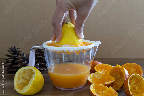 Fresh orange juice and lemonade in glasses.orange and lemon are a vitamin C store. Drinking natural fruit juice for healthy living. the woman squeezes fruit.