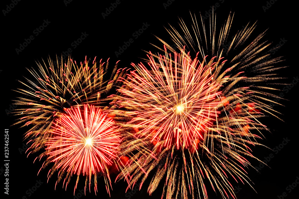 Gold and red fireworks on dark background