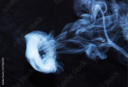 Wallpaper Mural White smoke ring on black fabric background. Smoke spreads over the background. Vaping culture, life without cigarettes. Conceptual image. Torontodigital.ca