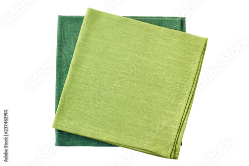 Two green folded textile napkins on white