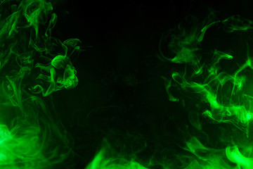 green smoke isolated on black background