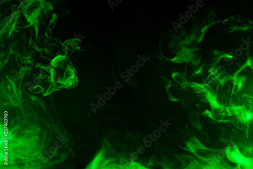 green smoke isolated on black background