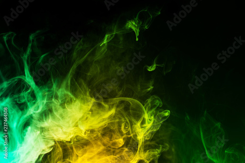abstract yellow and green smoke on black background 