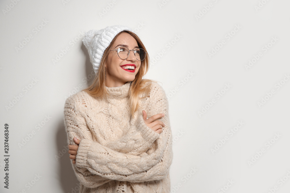Beautiful young woman in warm sweater with hat on white background. Space for text Beautiful young woman in warm sweater with hat on white background. Space for text