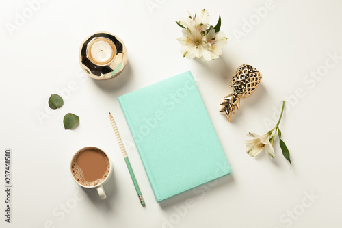 Flat lay composition with book, cup of coffee and decor elements on white background