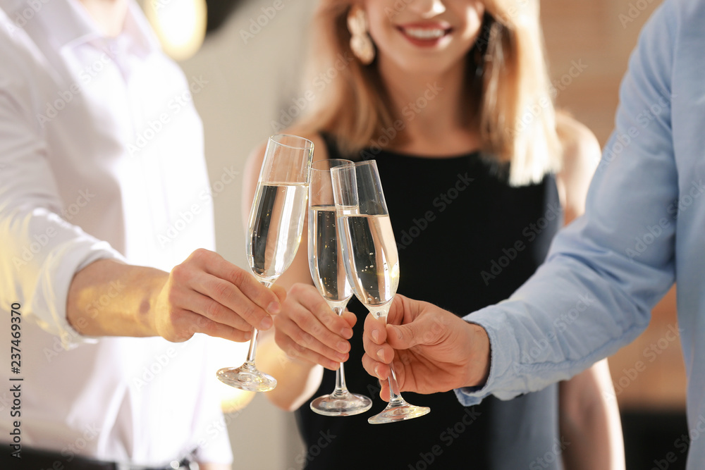 Friends clinking glasses with champagne at party indoors, closeup Friends clinking glasses with champagne at party indoors, closeup