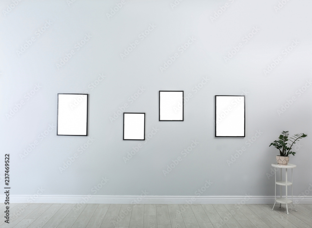 Frames with empty canvases on wall in modern art gallery. Mockup for design Frames with empty canvases on wall in modern art gallery. Mockup for design