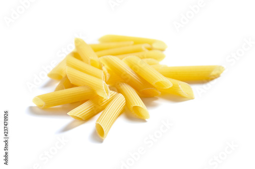 Uncooked penne rigate italian pasta, isolated on white background