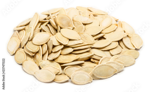 Handful of pumpkin seeds in the shell  close up  isolated on white background