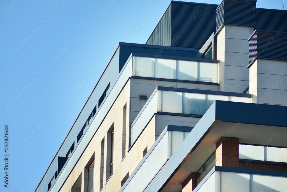 Modern apartment buildings on a sunny day with a blue sky. Facade of a modern apartment building Modern apartment buildings on a sunny day with a blue sky. Facade of a modern apartment building