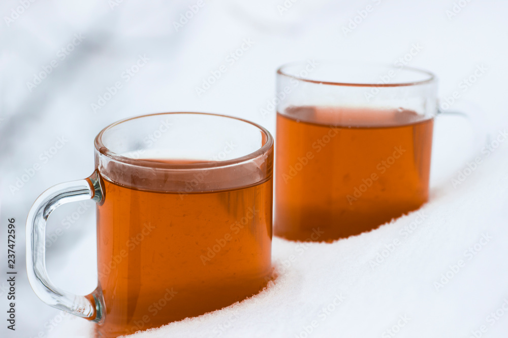 Two cups with hot tea in the snow Two cups with hot tea in the snow