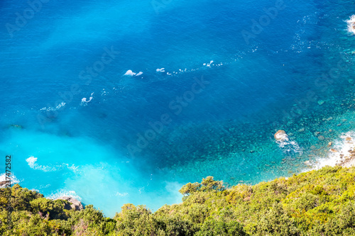 Rocks in the blue Mediterranean Sea on a bright sunny day.