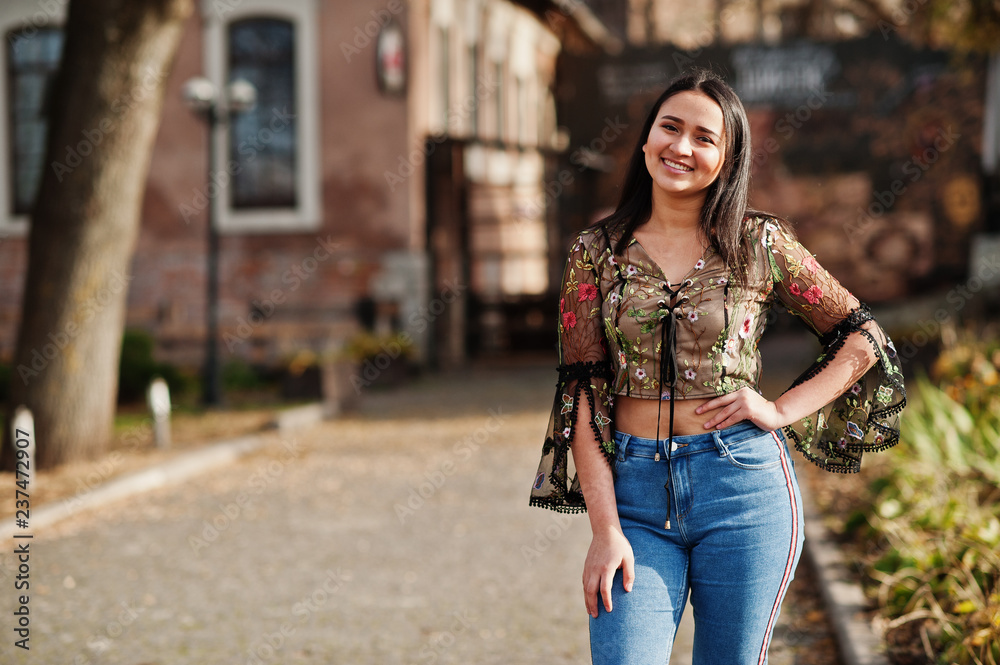 Pretty latino model girl from Ecuador wear on jeans posed at street. Pretty latino model girl from Ecuador wear on jeans posed at street.