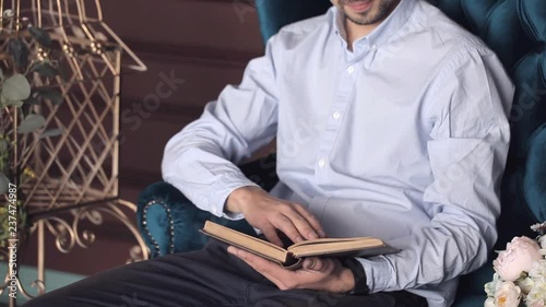 a man sitting in a chair in his library reading a book