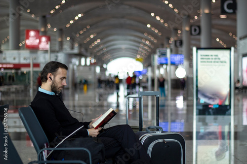 Passenger reading a book at the airport