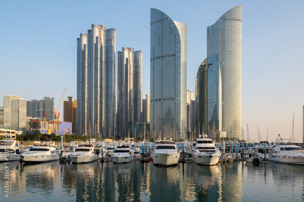 Busan city skyline view at Haeundae district, Gwangalli Beach with yacht pier at Busan, South Korea.