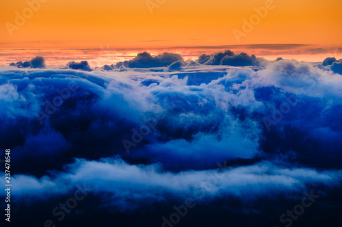 Clouds at sunrise over Haleakala Crater, Maui, Hawaii, USA