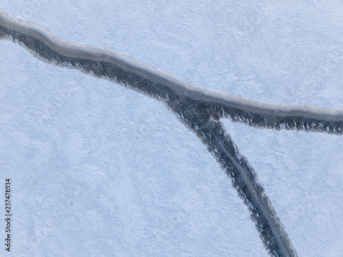 Aerial view of a rift on the ice of a winter lake 