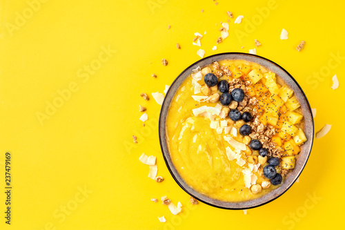 Top view of mango smoothie bowl with fruits