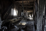 Abandoned factory. Old dusty band conveyer in old corridor of reinforced concrete plant