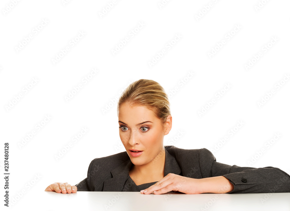 Businesswoman under the desk and based on it Businesswoman under the desk and based on it
