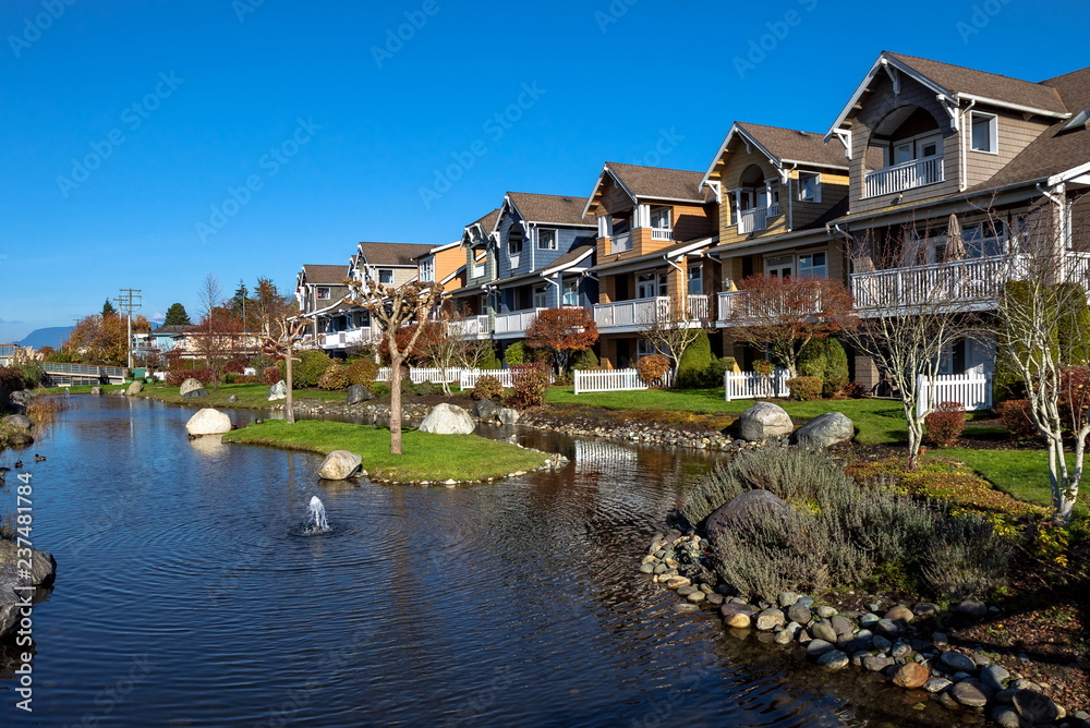 New residential area in a picturesque location near a pond with a fountain in the city of Richmond