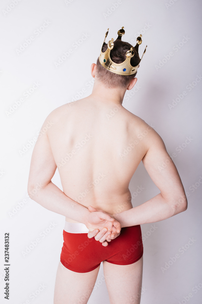sexy guy with red boxer briefs. a man with a crown on his head. body parts:  back and elastic ass in underwear. men's health: hemorrhoids and curvature  of the spine Stock Photo