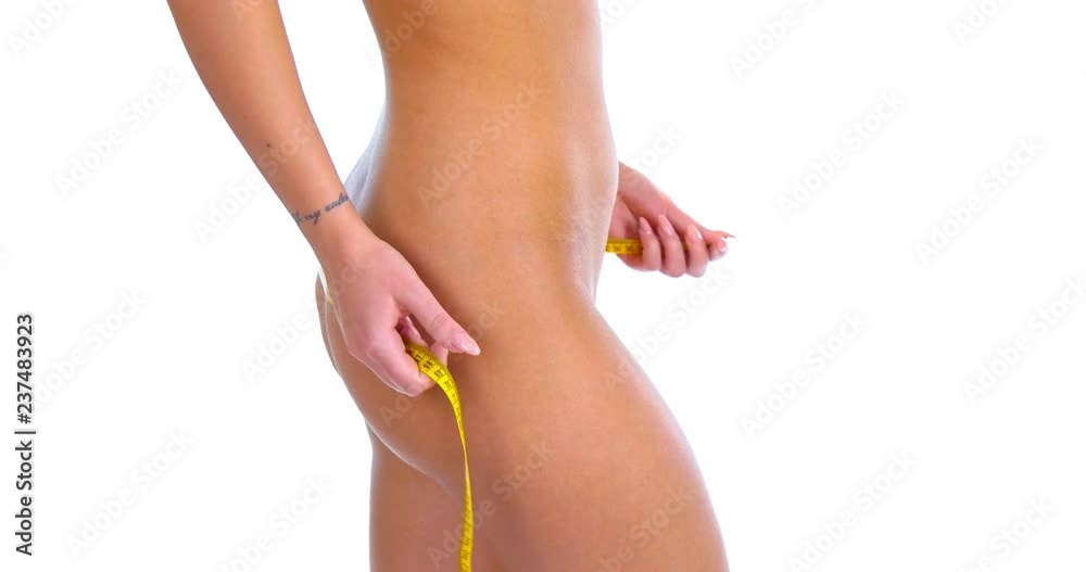 Woman measuring hips. Perfect body concept Woman measuring hips. Perfect body concept